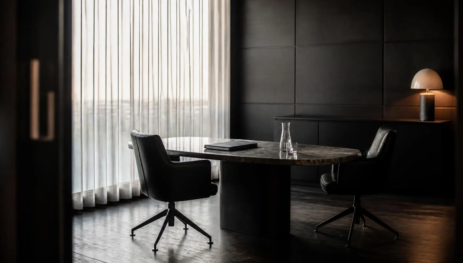 Private consultation office with leather chairs and a dark table set for a cannabis accounting meeting